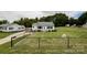 Charming home with black-fenced front yard and well-manicured lawn, complemented by mature trees and landscape at 109 Georgia Belle Ave # 199, Belmont, NC 28012