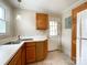 Bright kitchen featuring stainless steel sink, wooden cabinets, white countertops, and a door to the outside at 109 Georgia Belle Ave # 199, Belmont, NC 28012