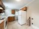 Spacious kitchen featuring white appliances and wooden cabinets at 109 Georgia Belle Ave # 199, Belmont, NC 28012