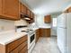 Functional kitchen with wooden cabinets, white appliances, and ample counter space at 109 Georgia Belle Ave # 199, Belmont, NC 28012