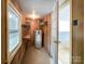 Utility room featuring a hot water tank, shelving, window and view of a room beyond at 109 Georgia Belle Ave # 199, Belmont, NC 28012
