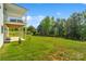 Large, level backyard featuring a covered patio and lush green grass at 11228 Island View Ln, Lancaster, SC 29720