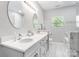 Well-lit primary bathroom with dual sinks, marble countertops, and garden tub at 11228 Island View Ln, Lancaster, SC 29720