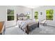 Cozy bedroom featuring a wrought iron bed frame and two windows with outdoor views at 11228 Island View Ln, Lancaster, SC 29720