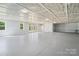 Spacious bonus room with painted concrete floors, light-colored walls, and coffered ceilings at 11228 Island View Ln, Lancaster, SC 29720