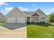 Charming one-story home with a two-car garage, manicured lawn, and inviting entryway at 11228 Island View Ln, Lancaster, SC 29720