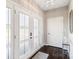 Bright foyer with elegant lighting, glass paneled front doors, and dark hardwood floors at 11228 Island View Ln, Lancaster, SC 29720
