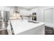 Modern kitchen island featuring white countertops and a stainless steel sink with barstool seating at 11228 Island View Ln, Lancaster, SC 29720