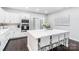 Well-lit kitchen with white cabinets, stainless steel appliances, and a center island with seating at 11228 Island View Ln, Lancaster, SC 29720