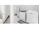 Laundry room showing washer and dryer units, and storage, as well as the entrance to the powder bath at 11228 Island View Ln, Lancaster, SC 29720