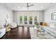 Bright living room with dark hardwood floors, a white sofa, and doors to a porch at 11228 Island View Ln, Lancaster, SC 29720