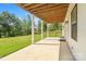 Covered patio with lush lawn, supported by white columns with a stained ceiling at 11228 Island View Ln, Lancaster, SC 29720