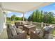 Covered porch featuring comfortable seating and wooded views at 11228 Island View Ln, Lancaster, SC 29720