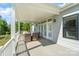 Covered porch area with comfortable wicker seating and wooded backdrop at 11228 Island View Ln, Lancaster, SC 29720