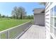 Expansive backyard features a well-maintained deck, mature trees, and manicured lawn at 115 Players Park Cir, Statesville, NC 28677