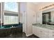 Bright bathroom featuring a luxurious jacuzzi tub, stand up shower, and lots of natural light at 115 Players Park Cir, Statesville, NC 28677