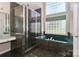 Bright bathroom with a glass-enclosed shower and a luxurious jacuzzi tub at 115 Players Park Cir, Statesville, NC 28677