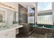 Elegant bathroom with a glass-enclosed shower, jacuzzi tub, and granite countertop vanity at 115 Players Park Cir, Statesville, NC 28677