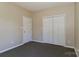 Neutrally painted bedroom featuring carpet and a closet for storage at 115 Players Park Cir, Statesville, NC 28677
