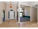 Grand foyer with tile floor, chandelier and view into the dining room with large windows at 115 Players Park Cir, Statesville, NC 28677