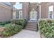 Inviting brick entrance with small brick steps, trimmed bushes and manicured landscape at 115 Players Park Cir, Statesville, NC 28677