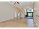 Bright living room with tile flooring, ceiling fan, and archway entrances at 115 Players Park Cir, Statesville, NC 28677