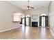 Open living room with fireplace, ceiling fan, and tile flooring at 115 Players Park Cir, Statesville, NC 28677