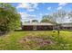 Expansive backyard showcasing the brick house's rear, metal roof, and lawn with potential garden or entertainment space at 1195 Ralph B Keener Rd, Lincolnton, NC 28092