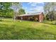 The backyard of this home features an open lawn and a brick exterior at 1195 Ralph B Keener Rd, Lincolnton, NC 28092