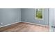 A clean bedroom is shown with fresh paint, light toned wood floors, and a bright window at 1195 Ralph B Keener Rd, Lincolnton, NC 28092