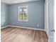 A clean bedroom is shown with fresh paint, light toned wood floors, and a bright window at 1195 Ralph B Keener Rd, Lincolnton, NC 28092