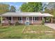 This charming brick home features a covered porch, and a long driveway at 1195 Ralph B Keener Rd, Lincolnton, NC 28092
