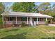 Charming brick home with a metal roof, covered porch, and a long driveway at 1195 Ralph B Keener Rd, Lincolnton, NC 28092