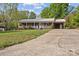 Charming brick home featuring a well-maintained yard, a metal roof, and an attached carport at 1195 Ralph B Keener Rd, Lincolnton, NC 28092