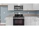 Close-up of stove and microwave in a kitchen with granite countertops at 1195 Ralph B Keener Rd, Lincolnton, NC 28092