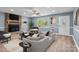 Staged living room with stone fireplace, large windows and comfortable furniture at 1195 Ralph B Keener Rd, Lincolnton, NC 28092