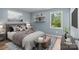 Relaxing main bedroom featuring neutral decor, shelves, and a bright window at 1195 Ralph B Keener Rd, Lincolnton, NC 28092