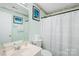 This simple bathroom features a single sink vanity and a shower/tub combination with a neutral color scheme at 12305 Portrush Ln, Charlotte, NC 28273