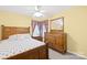 This cozy bedroom features wood furniture, neutral carpet, and a window at 12305 Portrush Ln, Charlotte, NC 28273