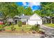 Charming single-story home with a well-manicured lawn and mature trees at 12305 Portrush Ln, Charlotte, NC 28273