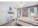 This charming main bedroom features neutral carpet, two windows, an attached ensuite bathroom, and a television at 12305 Portrush Ln, Charlotte, NC 28273