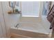 Bright bathroom features a relaxing soaking tub with a large window at 13015 Rothe House Rd, Charlotte, NC 28273