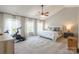 Spacious bedroom features an exercise bike, modern furniture, and bright natural light at 13015 Rothe House Rd, Charlotte, NC 28273