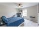 Comfortable bedroom with a ceiling fan, desk, and ample natural light at 13015 Rothe House Rd, Charlotte, NC 28273