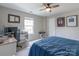 Comfortable bedroom with ceiling fan, desk, and personal touches at 13015 Rothe House Rd, Charlotte, NC 28273