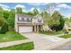 Beautiful two-story home with a spacious driveway, mature trees, and a well-manicured lawn at 13015 Rothe House Rd, Charlotte, NC 28273