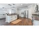 Open kitchen featuring stainless steel appliances, a center island, and hardwood floors for a modern look at 13015 Rothe House Rd, Charlotte, NC 28273
