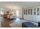 Bright and airy living room with hardwood floors, custom built-ins, and a view into the dining room at 13015 Rothe House Rd, Charlotte, NC 28273