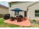 Outdoor patio with grill, seating, and blue umbrella at 13015 Rothe House Rd, Charlotte, NC 28273