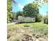 Spacious backyard with a fire pit and chain-link fence, and a wooden deck on the back of the home at 1307 Washington Ln, Kannapolis, NC 28083